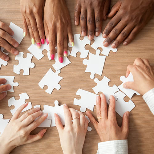multiethnic hands moving puzzle pieces